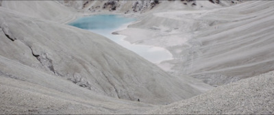 a mountain with a lake in the middle of it