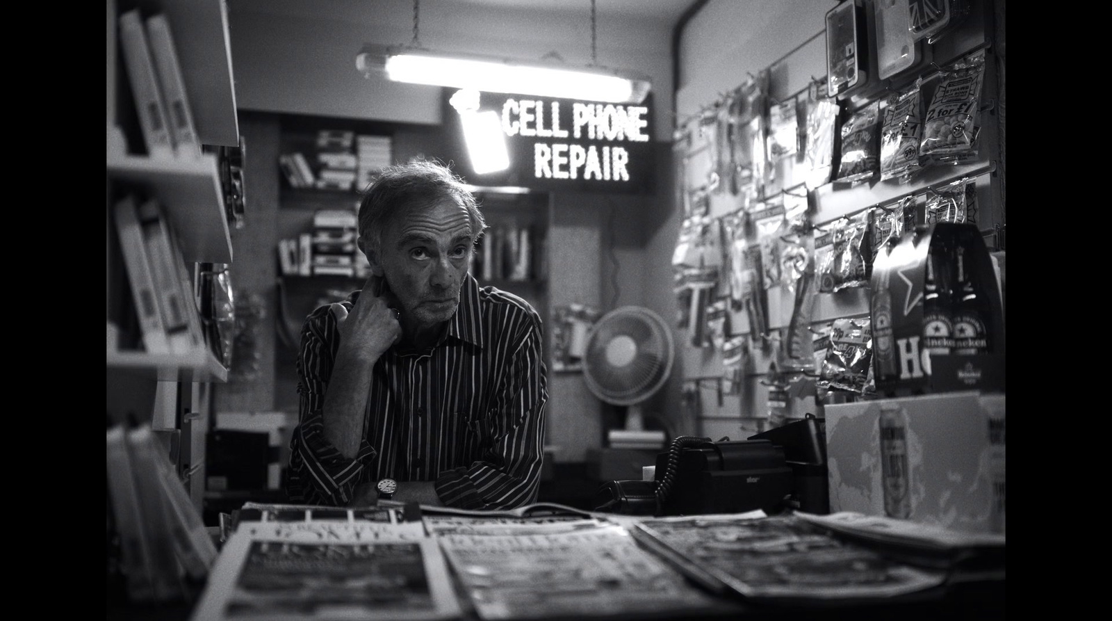 a man sitting at a desk in a store