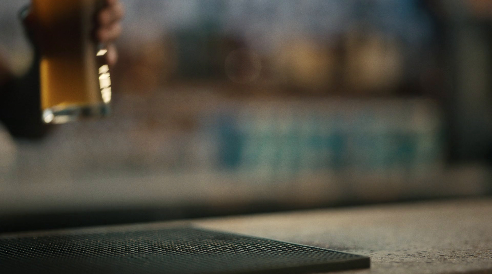 a close up of a person holding a glass of beer