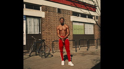 a man standing on a sidewalk in front of a building