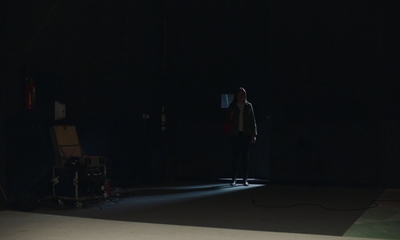 a person standing in a dark room in the dark