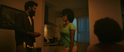 a man standing next to a woman in a kitchen