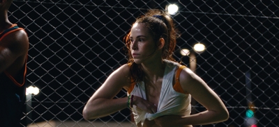 a woman holding a tennis racquet on a tennis court