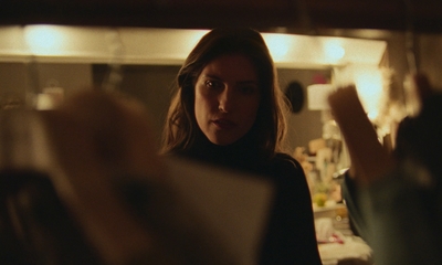 a woman standing in front of a mirror in a room