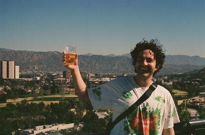 a man holding up a glass of beer