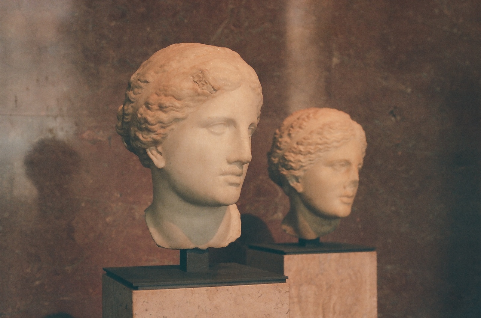 a marble bust of a man and a bust of a woman