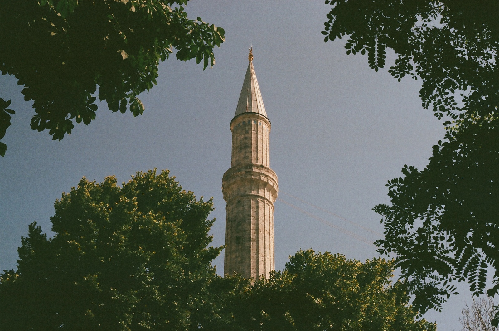 a very tall tower with a clock on it's side