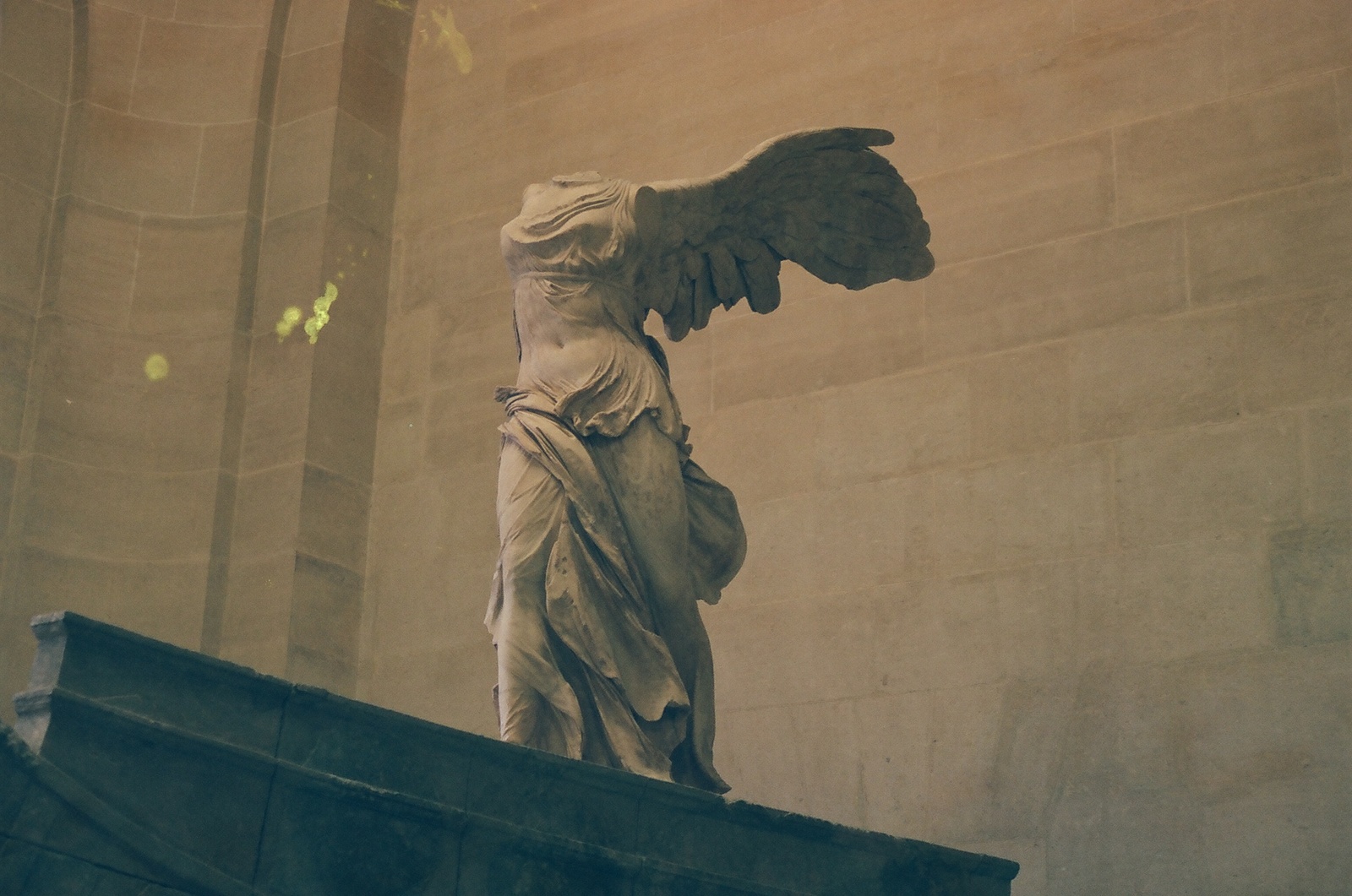 a statue of an angel on top of a building