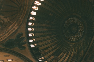 the ceiling of a building with a clock on it