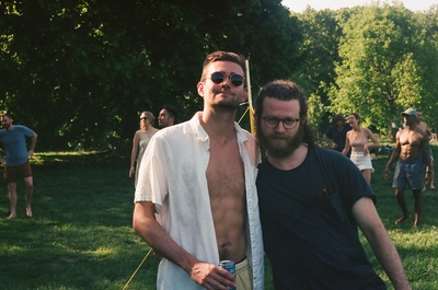 a couple of men standing next to each other on a field