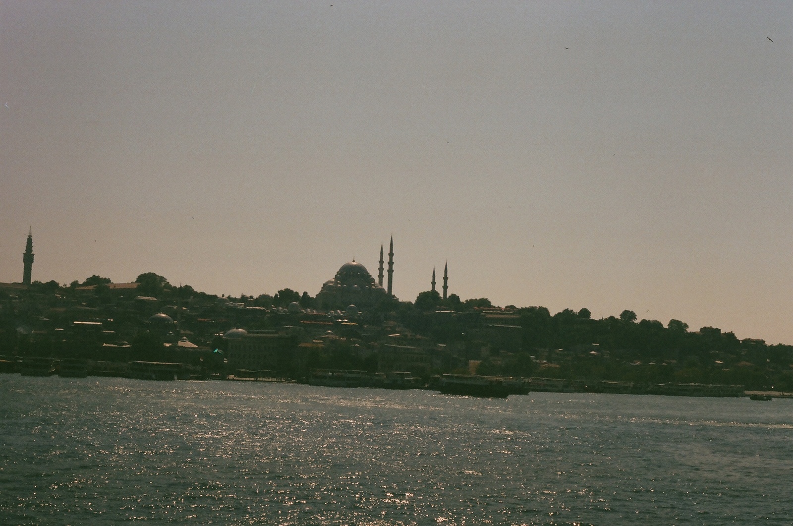 a large body of water with a city in the background