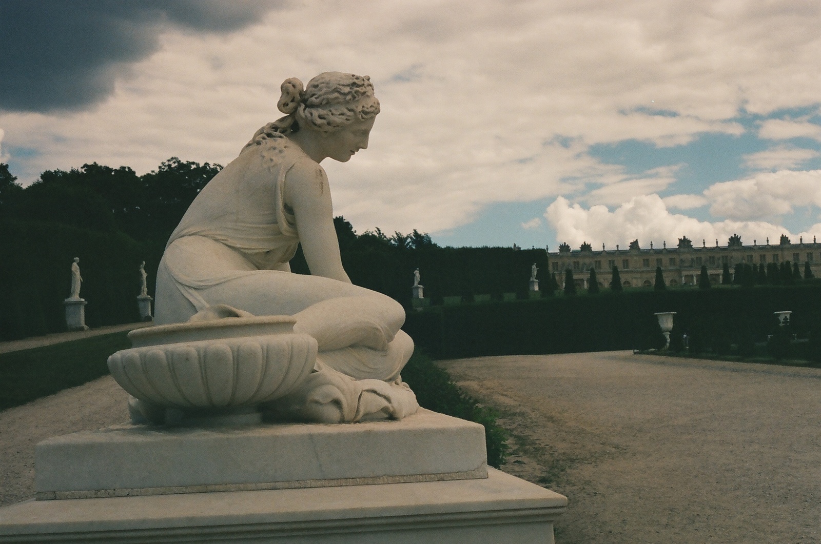 a statue of a woman sitting on a pedestal