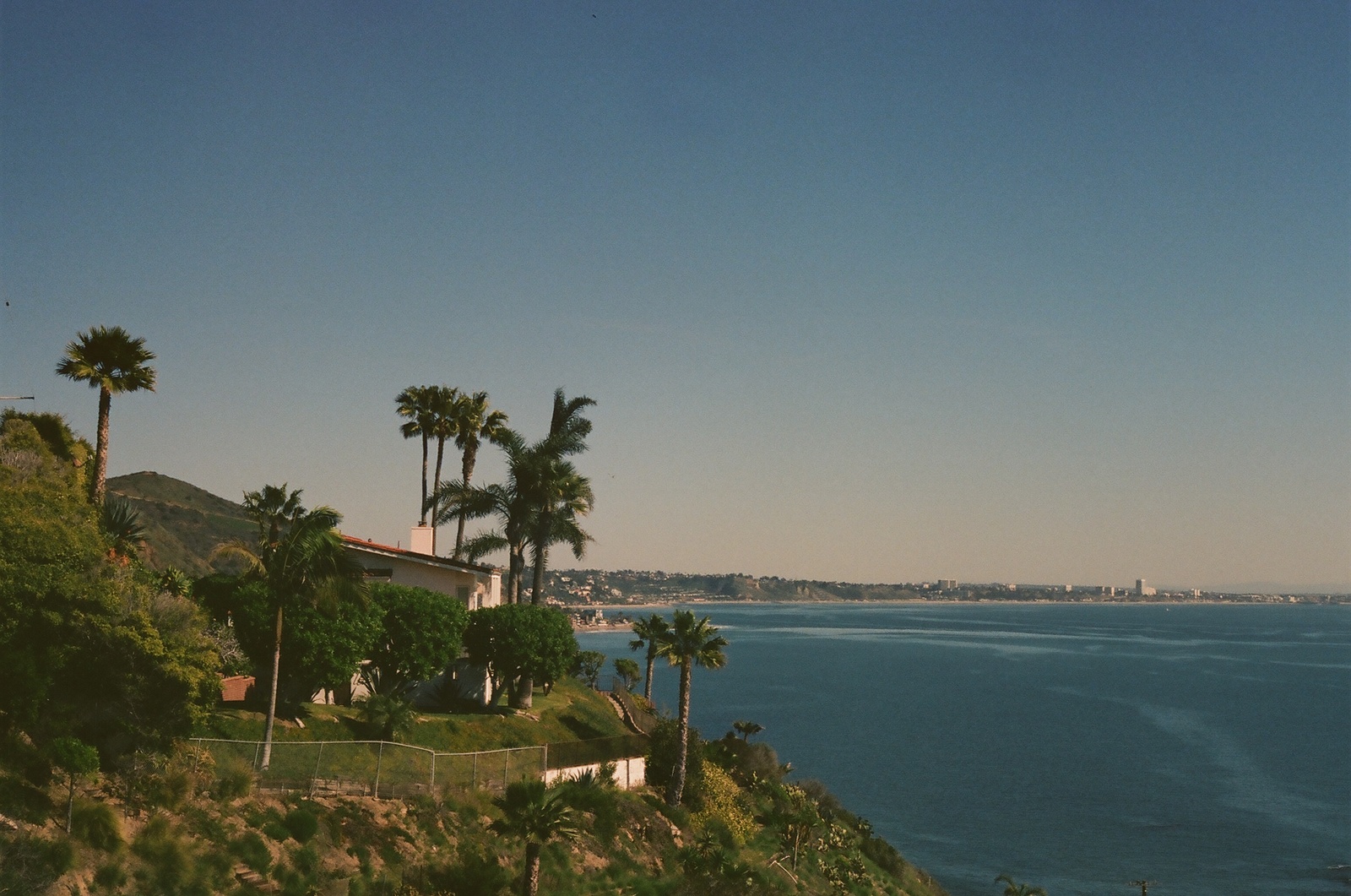 a house on a hill overlooking a body of water