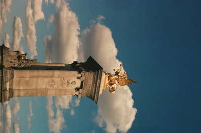 a tall tower with a statue on top of it