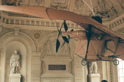 a model airplane hanging from the ceiling of a building