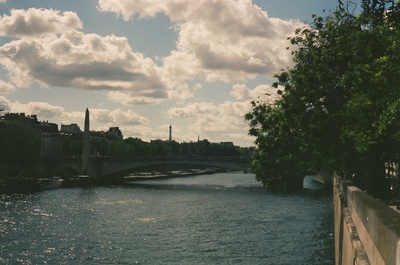 a view of a river with a bridge in the background