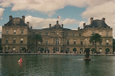 a large building with a pond in front of it