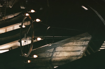 a clock hanging from the ceiling of a building