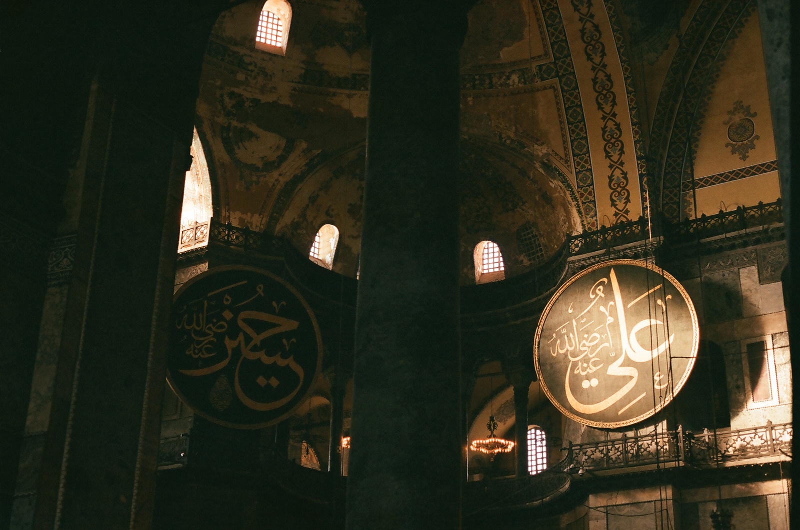 the interior of a large building with a clock on the wall