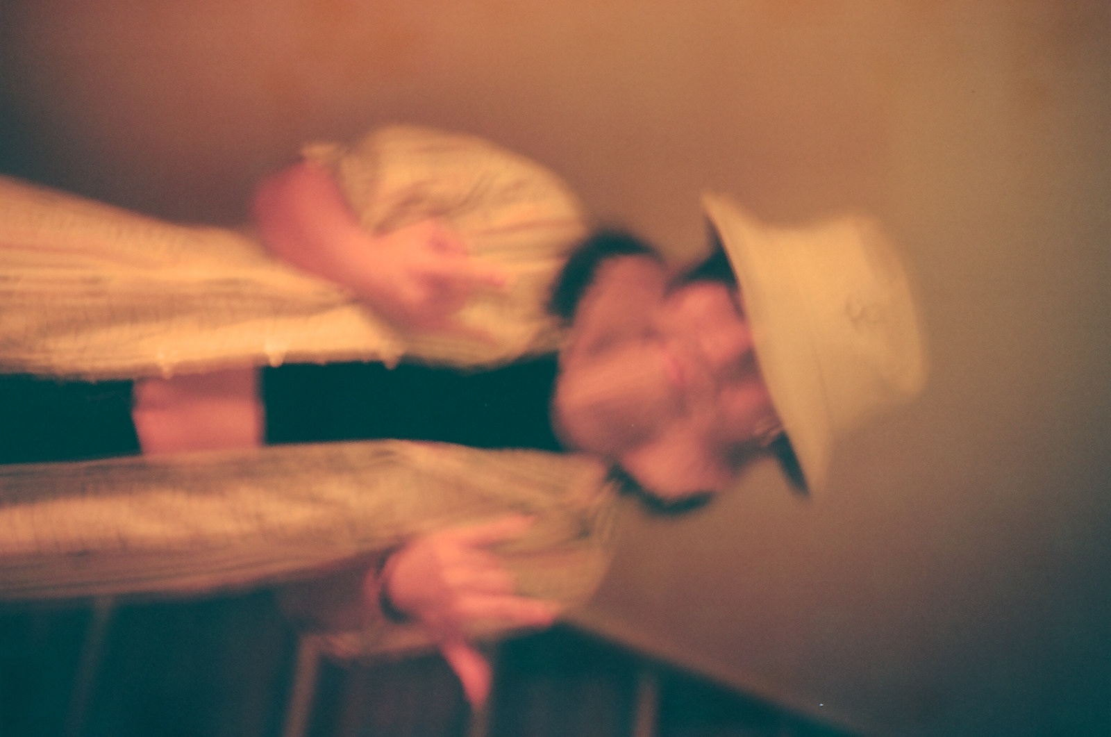 a blurry photo of a man wearing a hat