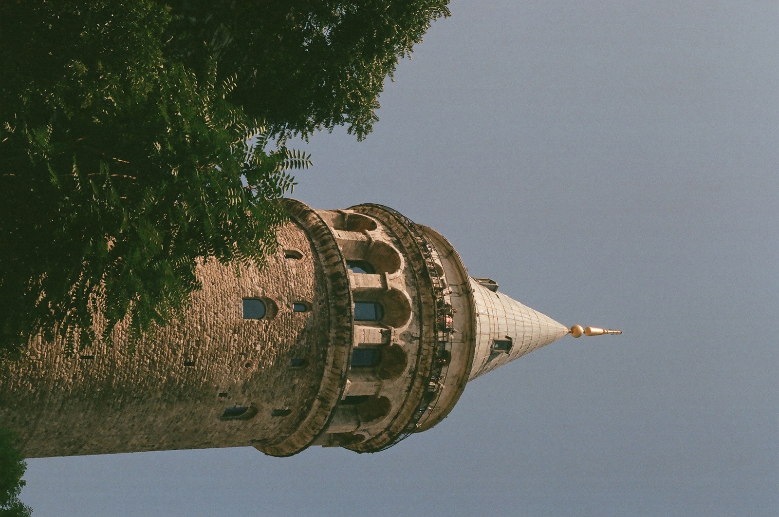 a very tall tower with a clock on it's side