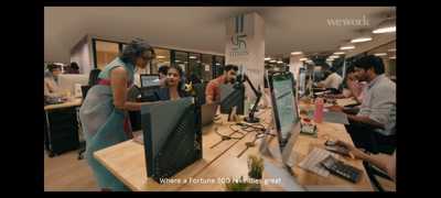 a group of people working on computers in an office