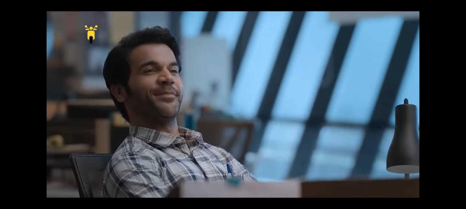 a man sitting in a chair smiling at the camera