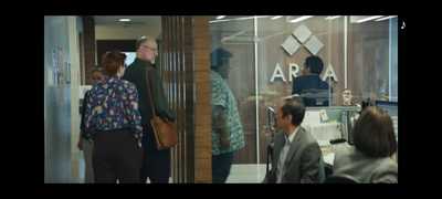 a group of people standing in front of a glass door