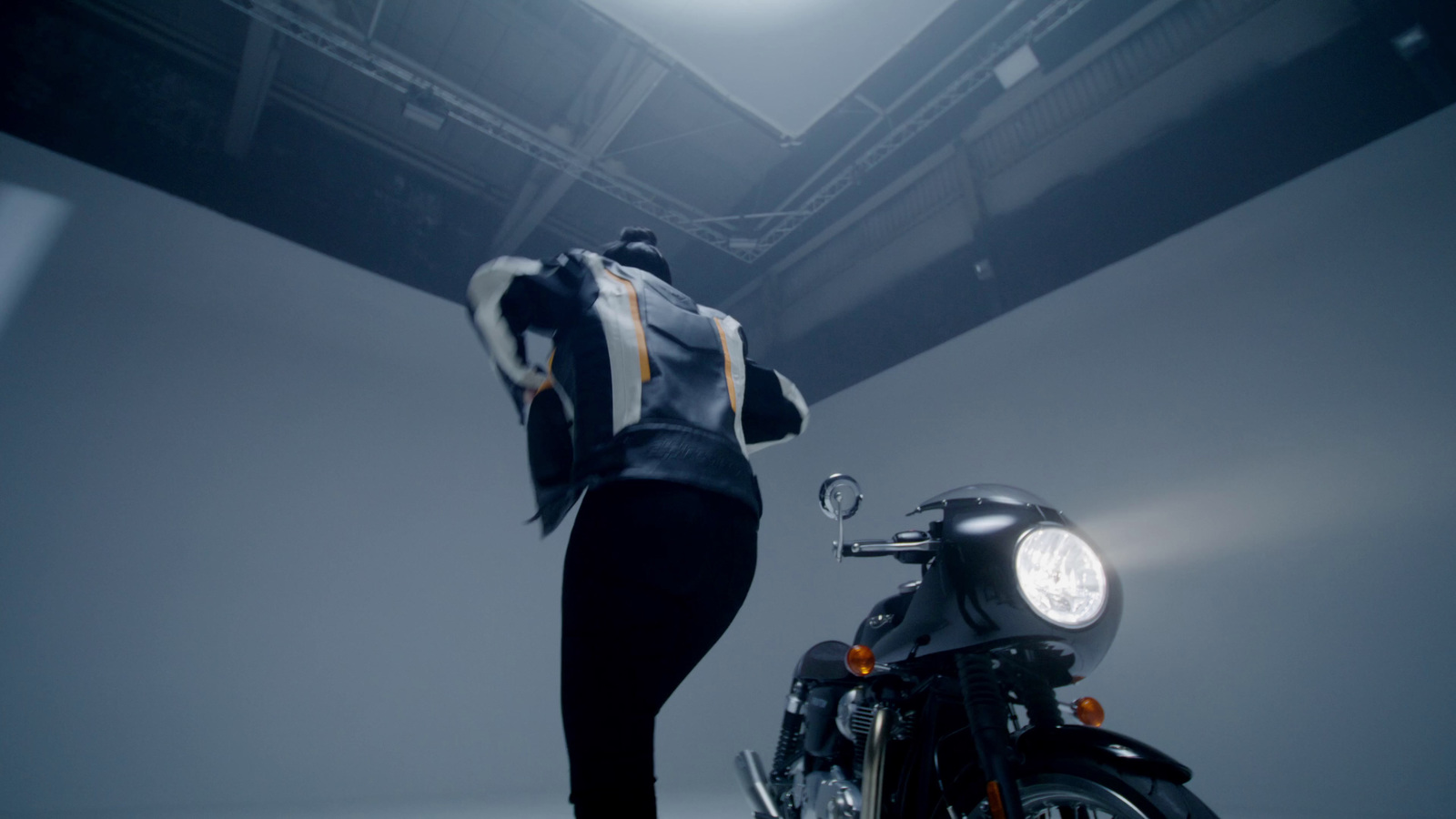 a person standing next to a motorcycle in a room