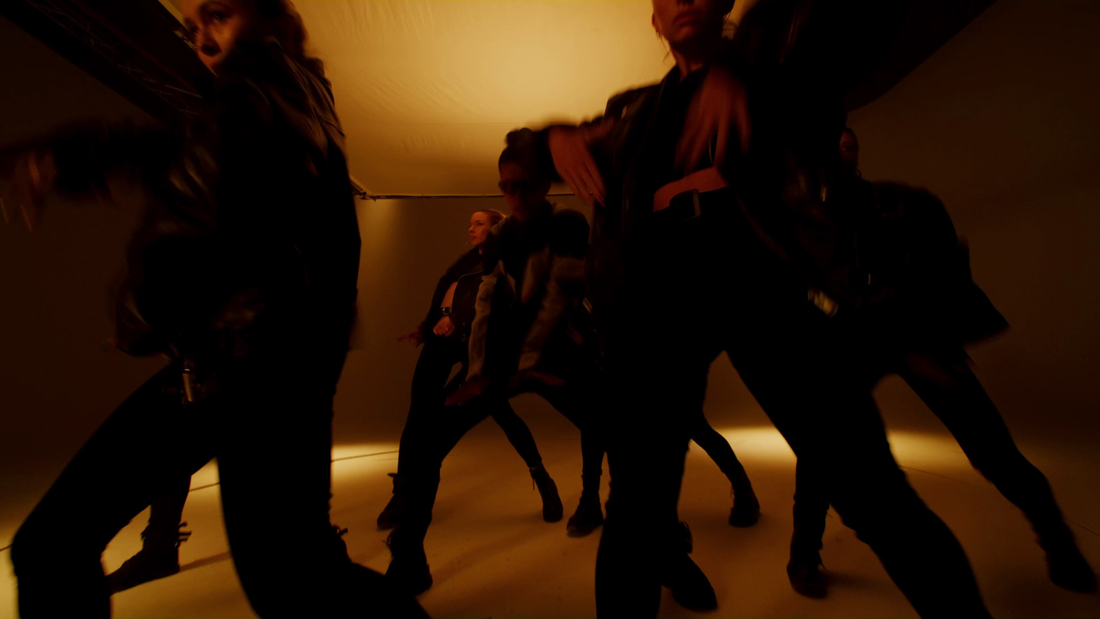 a group of people dancing in a dark room