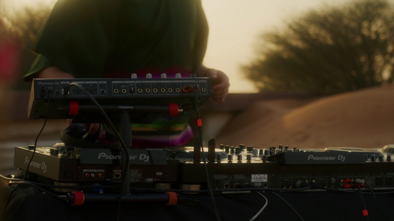 a dj mixing music in front of a house