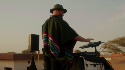 a man in a green hat is standing next to a bike