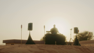 a person sitting on top of a vehicle in the desert