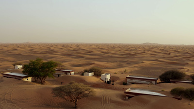 a group of huts in the middle of a desert