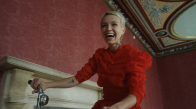 a woman in a red dress is laughing