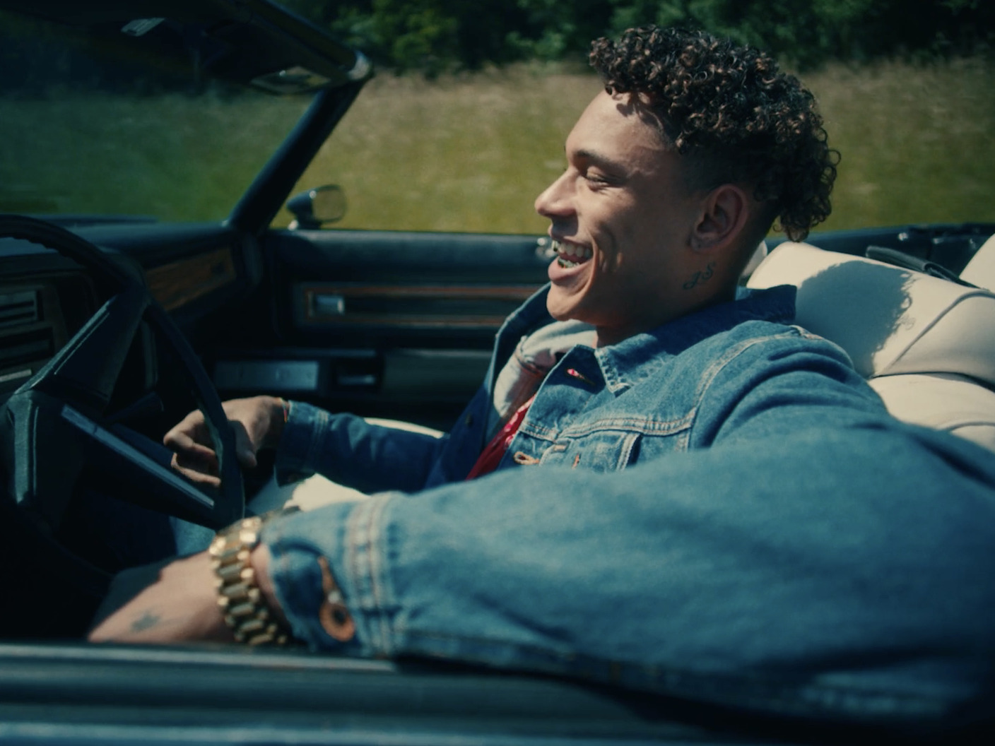 a man sitting in the driver's seat of a car