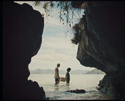 a couple of people standing on top of a body of water