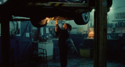 a man working on a car in a garage