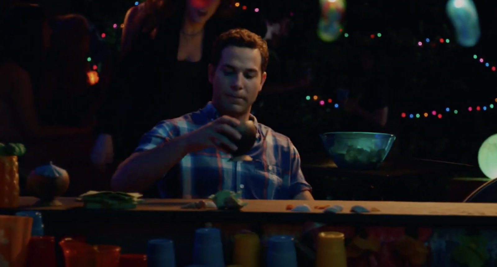 a man sitting at a table in front of a bowl of food