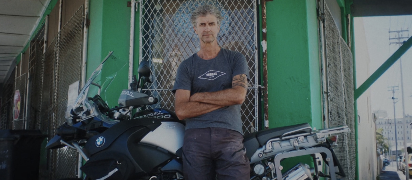 a man standing next to a parked motorcycle