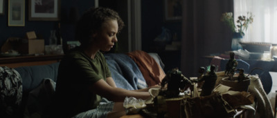 a young boy sitting on a couch in a living room