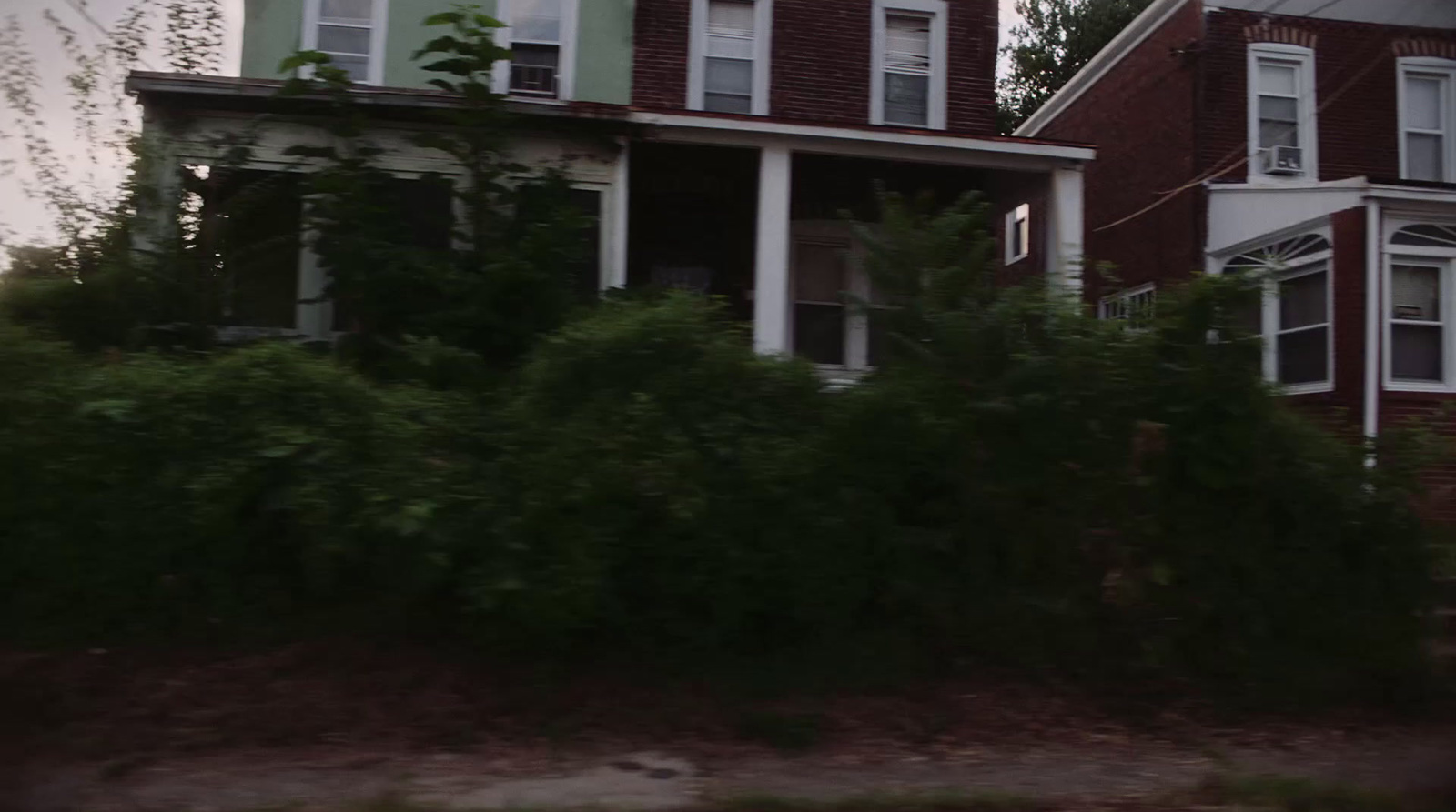 a large red brick house with white trim