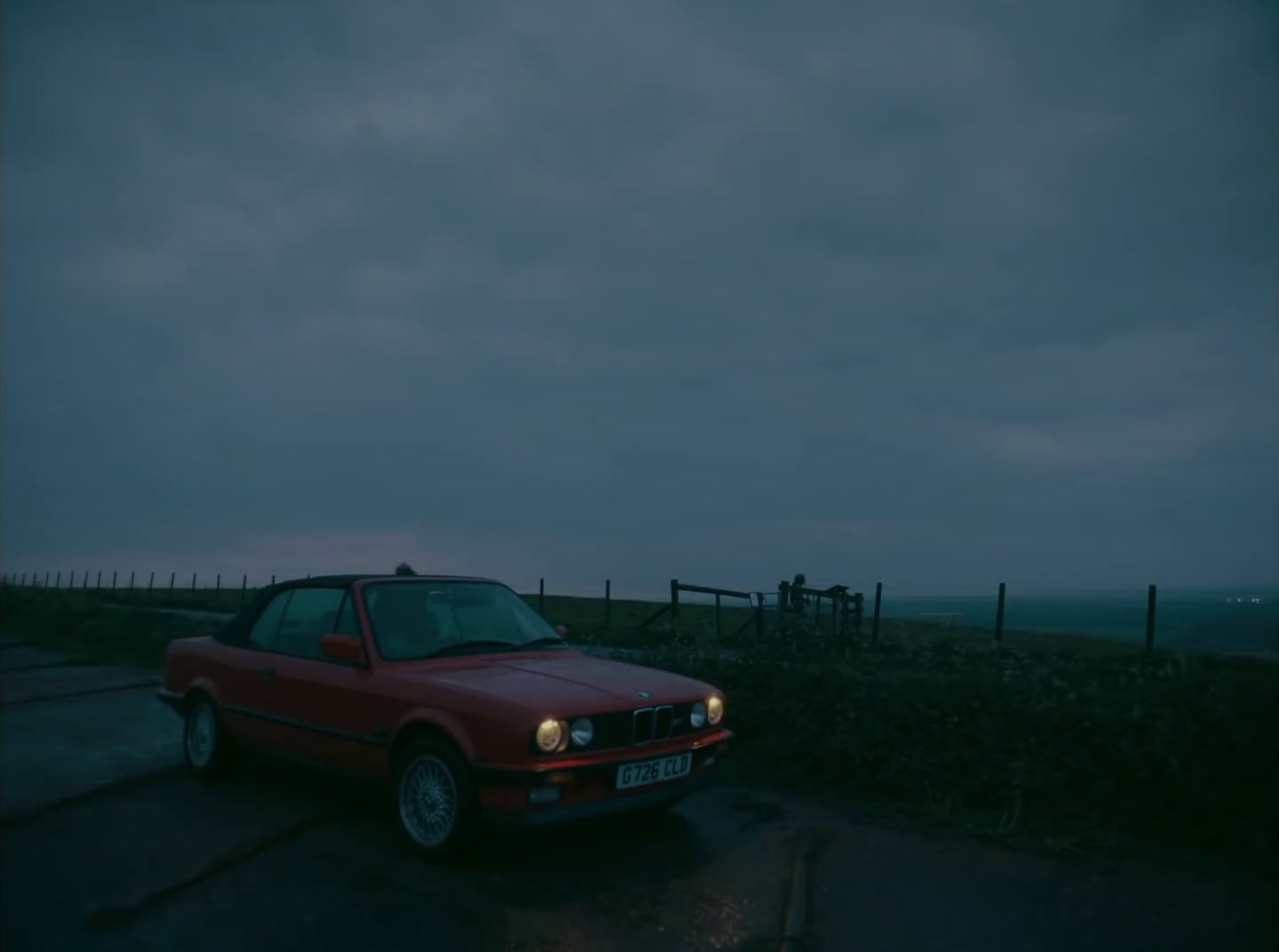 a red car parked on the side of a road