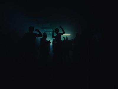 a group of people standing around in the dark