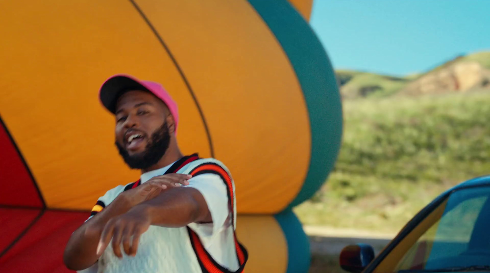 a man standing in front of a giant hot air balloon