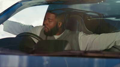 a man sitting in the drivers seat of a car