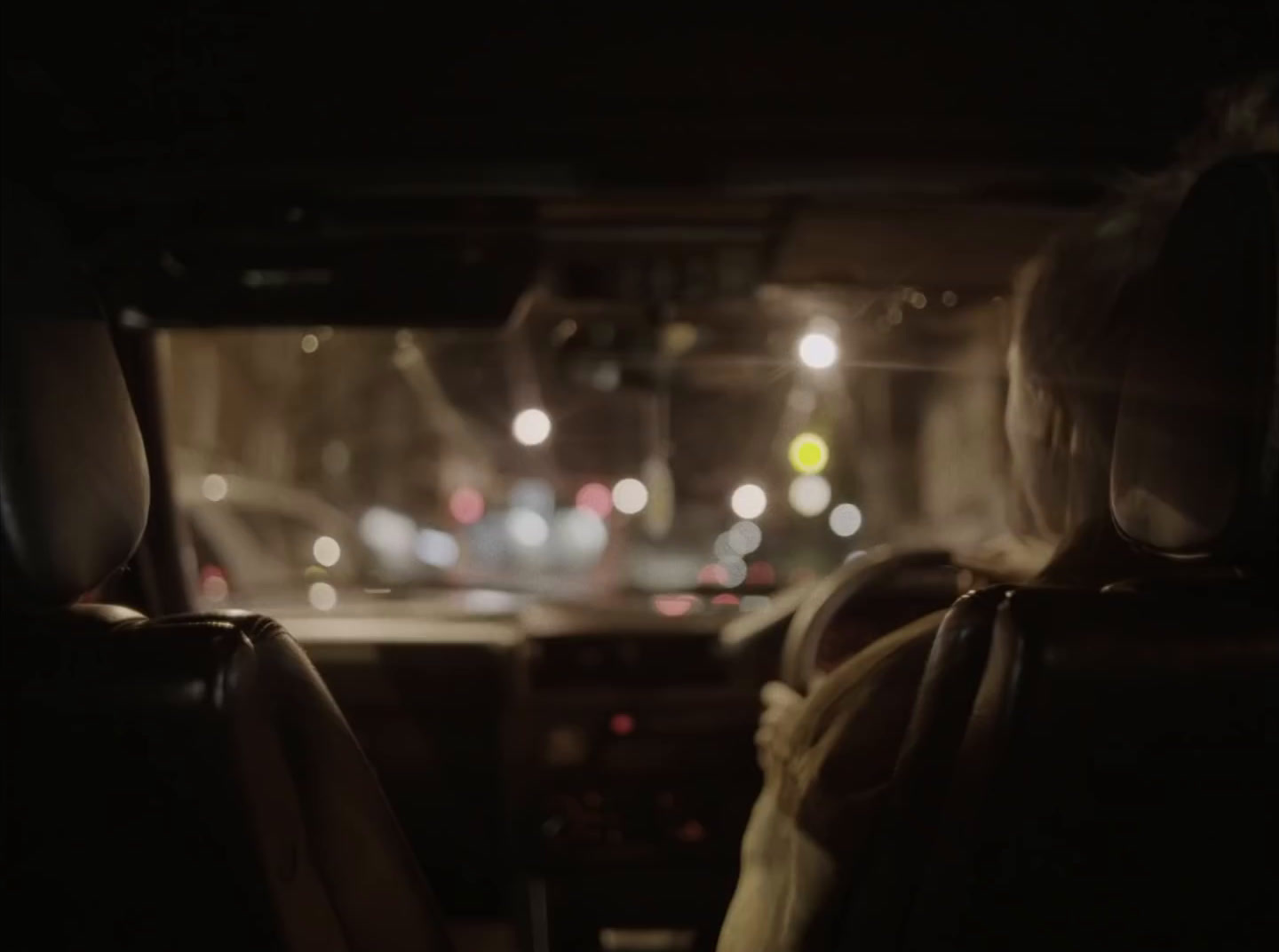 a person sitting in a car at night