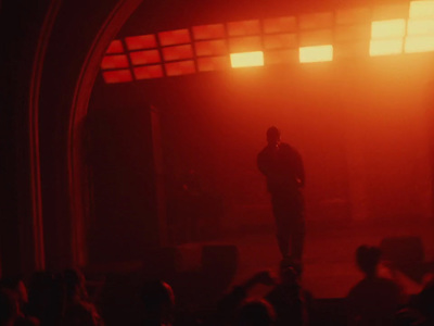 a man standing on top of a stage in front of a crowd