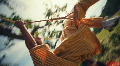 a person hanging on a wire with their hands