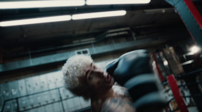 a man with white hair and tattoos in a gym